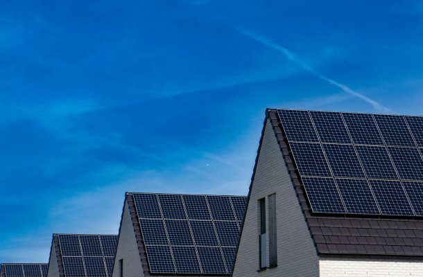 solar panels on roof tops of houses in a row